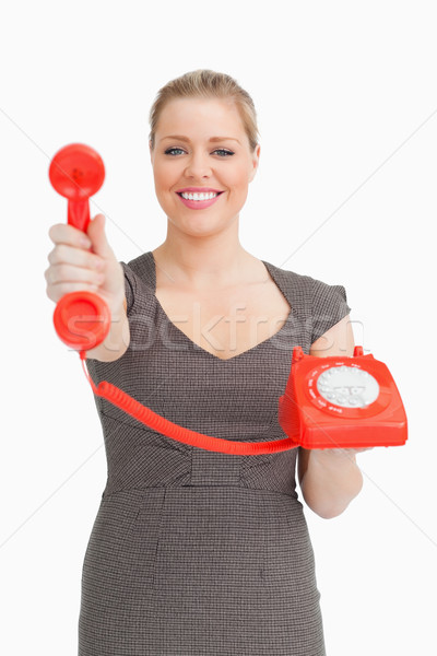 Woman showing a phone against white background Stock photo © wavebreak_media