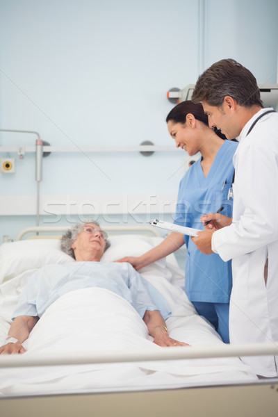Doctor and nurse talking with a patient in hospital ward Stock photo © wavebreak_media