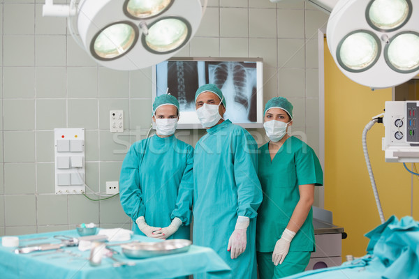 Serious medical team looking at camera in operating theater Stock photo © wavebreak_media