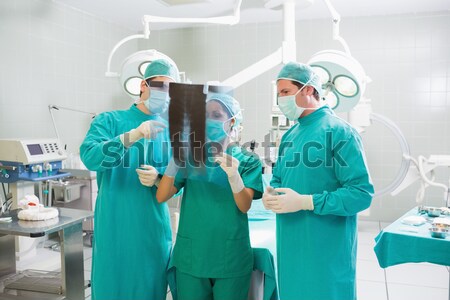 Stock photo: Surgeons standing up while smiling in an operating theatre