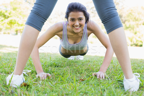 Smiling woman doing push ups in park Stock photo © wavebreak_media