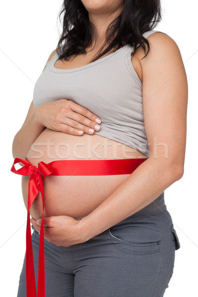 Terhes nő vörös szalag körül dudorodás fehér nő Stock fotó © wavebreak_media