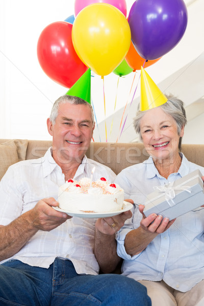 Couple de personnes âgées séance canapé célébrer anniversaire maison [[stock_photo]] © wavebreak_media