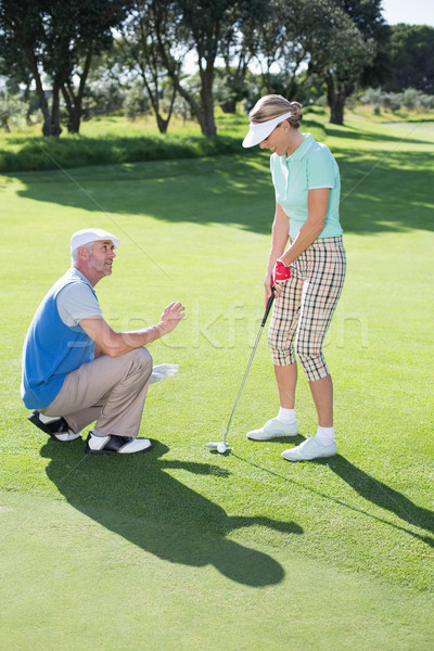 Man coaching his partner on the putting green Stock photo © wavebreak_media