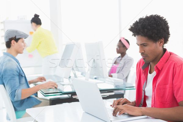 Foto stock: Jovem · criador · homem · usando · laptop · secretária · escritório