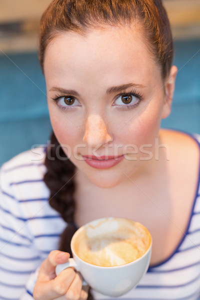 Young woman having a cappuccino Stock photo © wavebreak_media
