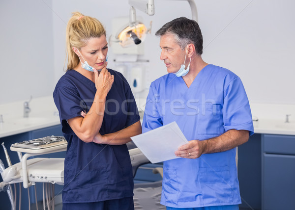 Thoughtful co-workers talking about a file attentively Stock photo © wavebreak_media