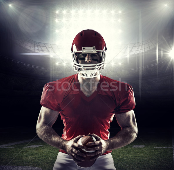 Stock photo: Composite image of american football player holding ball