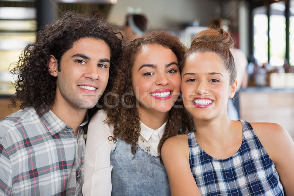 Smiling friends sitting at restaurant Stock photo © wavebreak_media