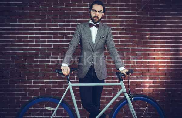Retrato inteligente homem bicicleta parede de tijolos em pé Foto stock © wavebreak_media