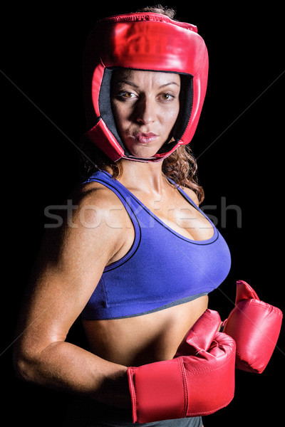 Portrait of pretty boxer with headgear and gloves Stock photo © wavebreak_media