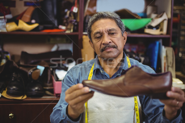 Shoemaker examining a shoe Stock photo © wavebreak_media