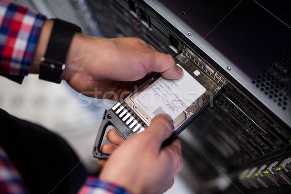 Technician inserting a hard disk drive into a blade server Stock photo © wavebreak_media