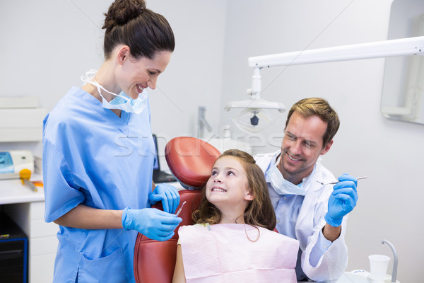 Smiling dentists interacting with young patient Stock photo © wavebreak_media