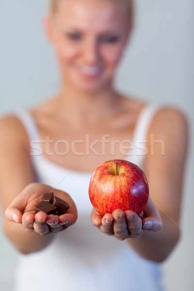Beautiful woman holding chocolate and apple focus on apple  Stock photo © wavebreak_media