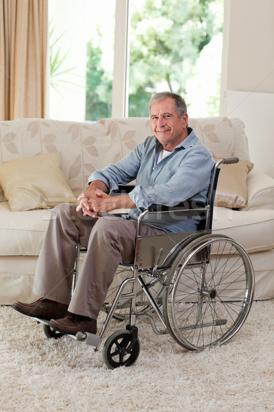 Stock photo: Senior man in his wheelchair at home