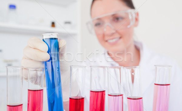 Attractive red-haired female holding a test tube in a lab Stock photo © wavebreak_media