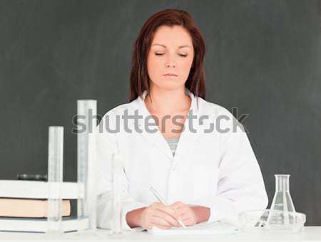 Focused scientist pourring a liquid in a graduated cylindre in a classroom Stock photo © wavebreak_media