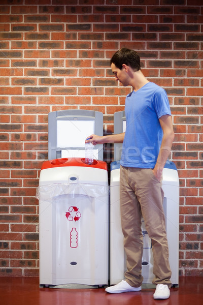 Portrait of a young man recycling a plastic bottle Stock photo © wavebreak_media