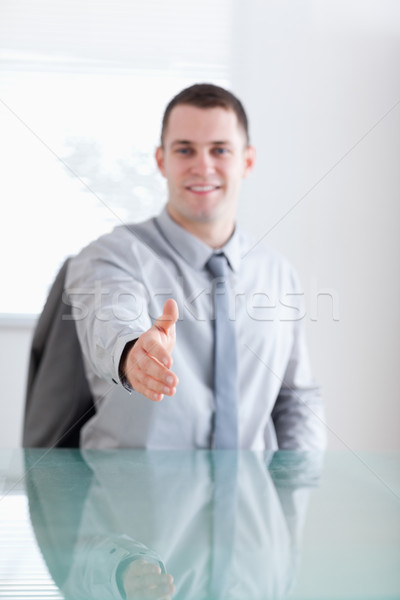 Close up of smiling young businessman greeting his negotiation partner Stock photo © wavebreak_media