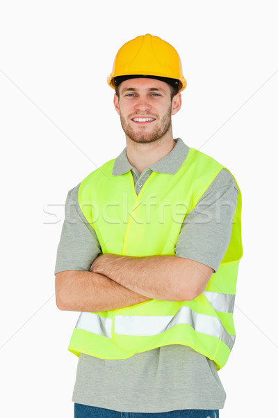 Souriant jeunes travailleur de la construction pliées bras blanche [[stock_photo]] © wavebreak_media