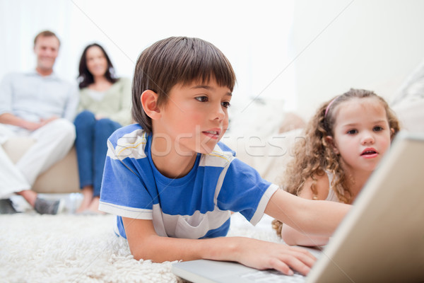 [[stock_photo]]: Jeunes · enfants · jouant · ordinateur · jeux · tapis · parents