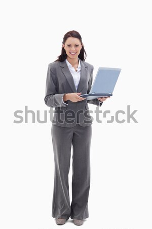 Businesswoman smiling with a laptop against white background Stock photo © wavebreak_media