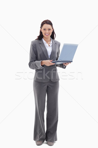 Businesswoman looking happy with a laptop against white background Stock photo © wavebreak_media