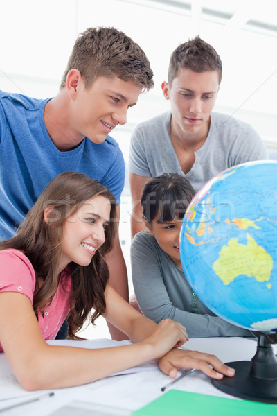 A close up shot of people looking at the globe in front of them Stock photo © wavebreak_media