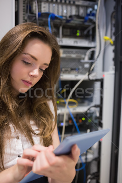 Woman working on servers checking tablet pc in data center Stock photo © wavebreak_media