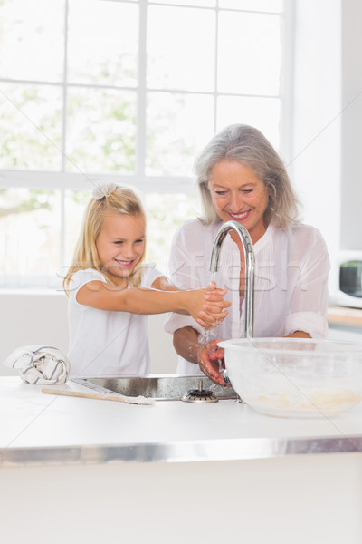 Stock photo: Happy grandmother and granddaughter washing hands