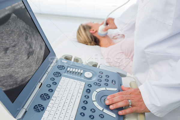 Doctor using sonogram on neck of female patient Stock photo © wavebreak_media