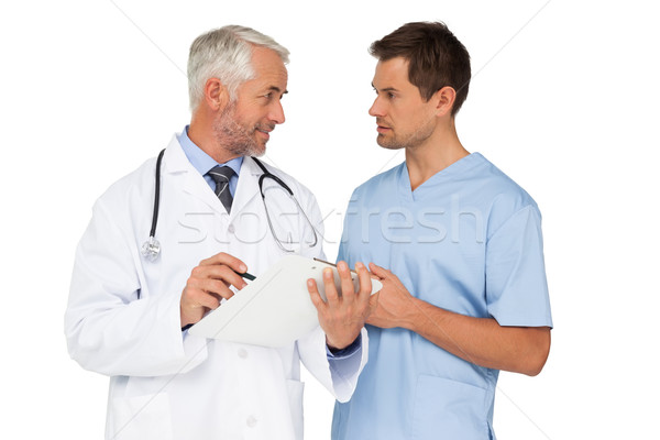 Médico do sexo masculino cirurgião discutir relatórios branco homem Foto stock © wavebreak_media
