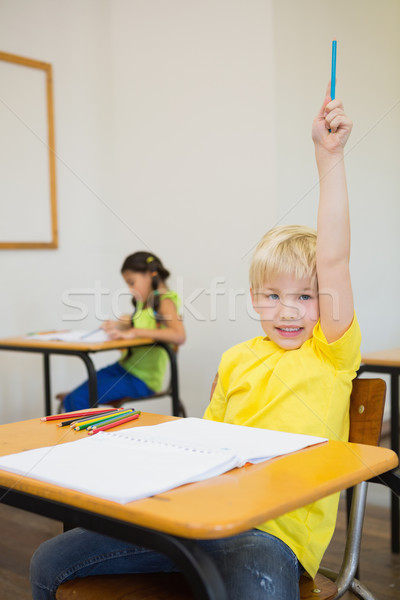 Cute pupils colouring at desks in classroom Stock photo © wavebreak_media