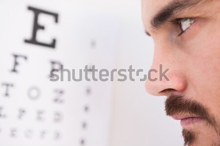 Focused man on eye test letters Stock photo © wavebreak_media