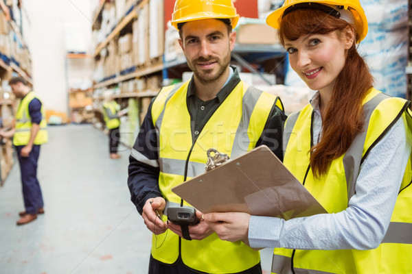 Warehouse team working together with clipboard Stock photo © wavebreak_media