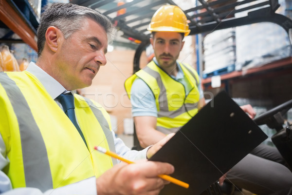 Forklift driver talking with his manager Stock photo © wavebreak_media
