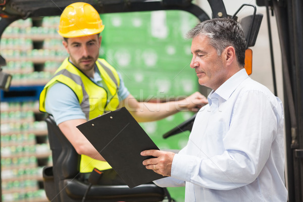 Forklift driver talking with his manager Stock photo © wavebreak_media