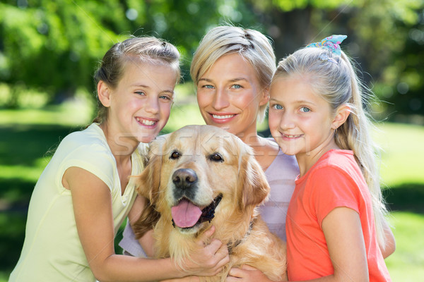 Сток-фото: счастливая · семья · собака · женщину · дерево · счастливым