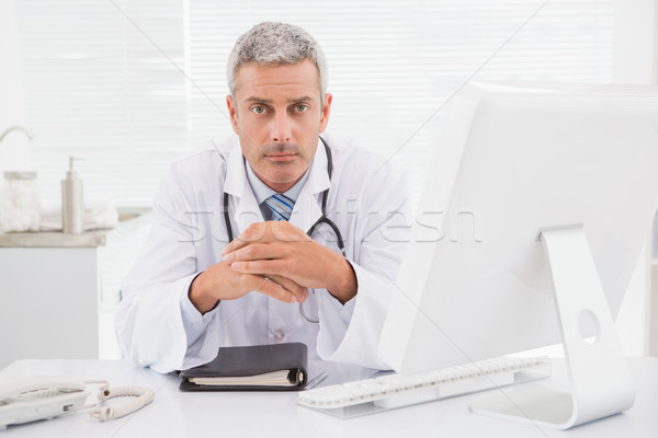 Unsmiling doctor looking at camera  Stock photo © wavebreak_media