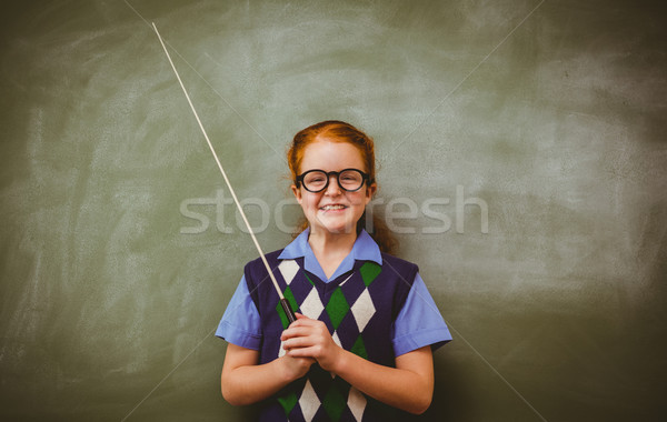 Llittle girl holding stick in front of blackboard Stock photo © wavebreak_media