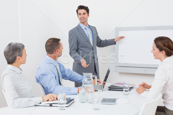 бизнесмен указывая белый экране служба женщину Сток-фото © wavebreak_media