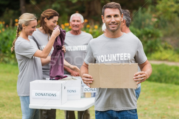 Stock photo: Happy volunteer family holding donation boxes 