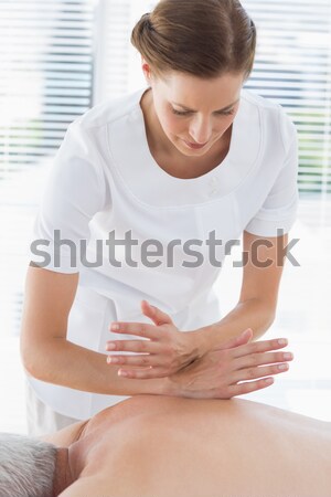 Female masseur massaging womans leg Stock photo © wavebreak_media