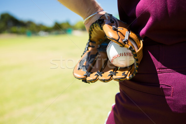 Mid section of baseball pitcher holding ball in glove Stock photo © wavebreak_media