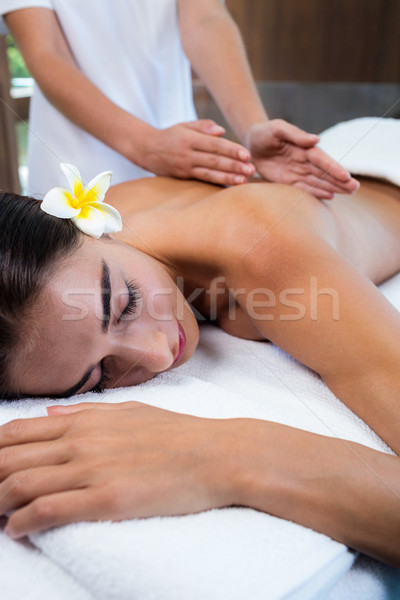 Masseuse giving massage to relax woman Stock photo © wavebreak_media