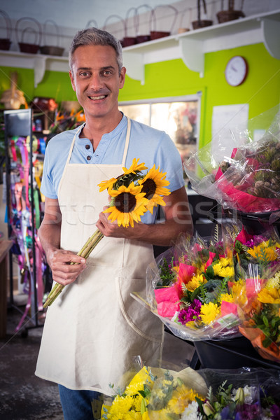 Male florist holding bunch of yellow sunflower Stock photo © wavebreak_media