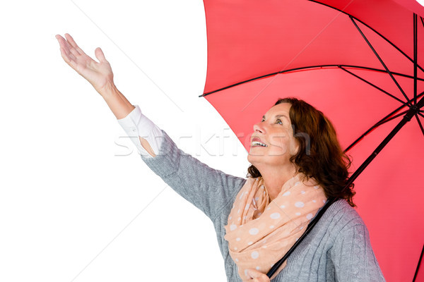 Mature woman holding umbrella Stock photo © wavebreak_media