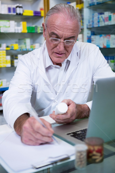 Pharmacist writing prescriptions for medicines Stock photo © wavebreak_media