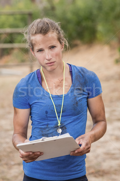 Portrait of female trainer holding clipboard during obstacle course Stock photo © wavebreak_media